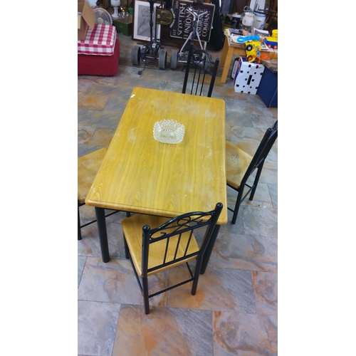 308 - Wooden dining set includes a rectangular table and four chairs with metal accents.