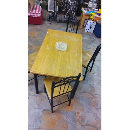 308 - Wooden dining set includes a rectangular table and four chairs with metal accents.