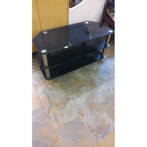 309 - Modern black glass TV stand with three-tier shelving and metal supports.