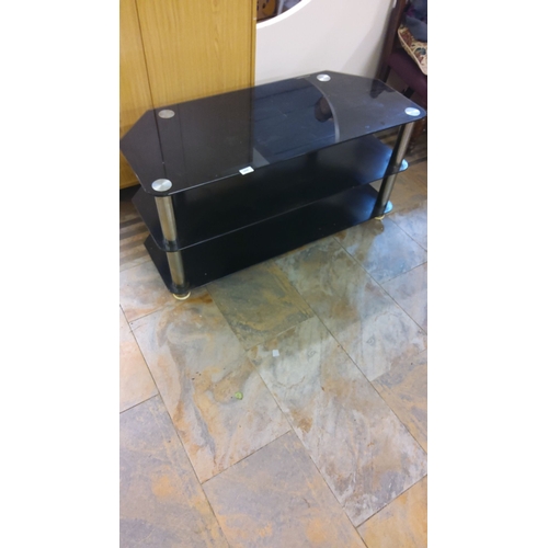 309 - Modern black glass TV stand with three-tier shelving and metal supports.