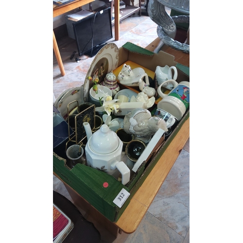 312 - Collection of assorted ceramic and porcelain items, including teapots, decorative plates, and mugs. ... 