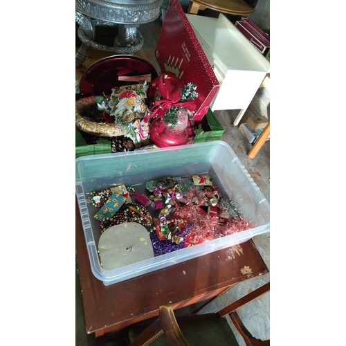 314 - Collection of assorted Christmas decorations, including baubles, tinsel, and beads, in vibrant color... 