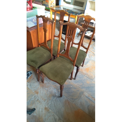 315 - Set of four antique mahogany 
dining chairs with green upholstered seats, featuring elegant curved b... 