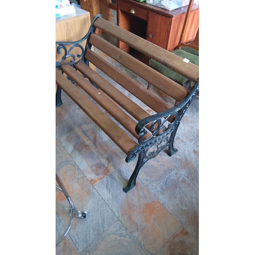 316 - Cast Iron ends garden bench with wooden slats, featuring decorative sides.