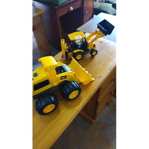 318 - Two Caterpillar toy construction vehicles, consisting of a yellow dump truck and backhoe loader, mad... 