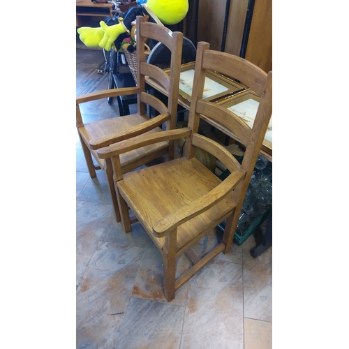 325 - Pair of oak armchairs feature slatted backs and sturdy construction. Classic design.