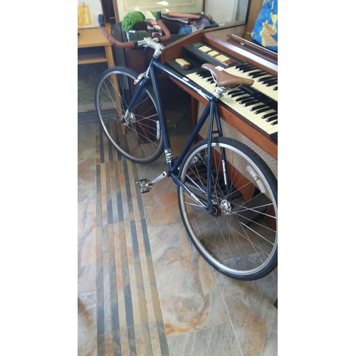 329 - Charge Racing bike with a sleek navy frame, brown leather saddle, and matching handlebar grips.