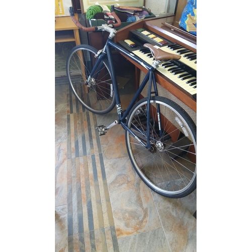 329 - Charge Racing bike with a sleek navy frame, brown leather saddle, and matching handlebar grips.