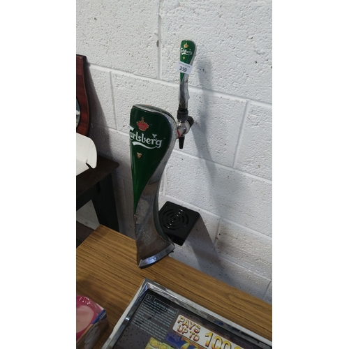 339 - Carlsberg branded beer tap handle features a sleek green and chrome design.