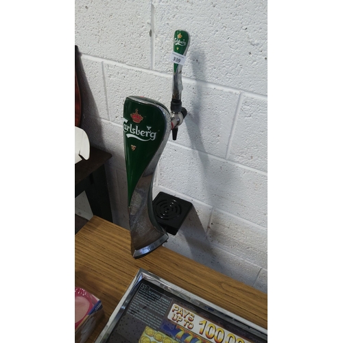 339 - Carlsberg branded beer tap handle features a sleek green and chrome design.