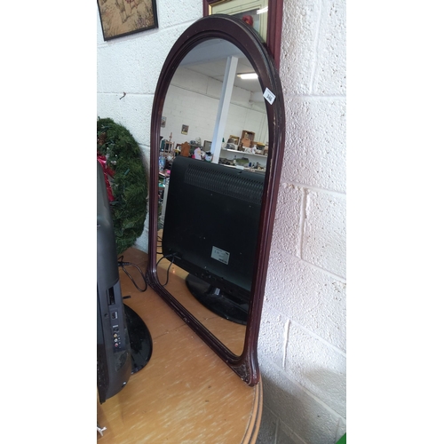 346 - Arched wall mirror with dark wooden frame.