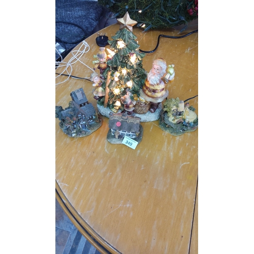 349 - Ceramic scene featuring a lighted Christmas tree, Santa, and three village houses.