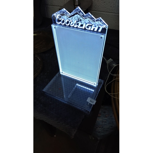 351 - Coors Light  display stand features a mountain motif and is illuminated.