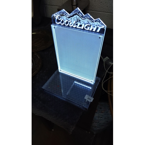 351 - Coors Light  display stand features a mountain motif and is illuminated.