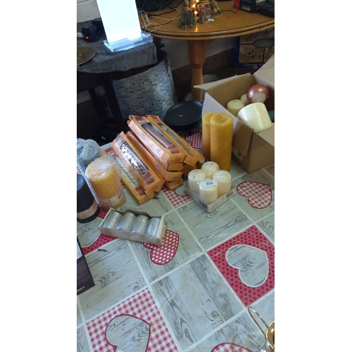 354 - Large assortment of decorative candles, including boxed and unboxed varieties in varied shapes and s... 