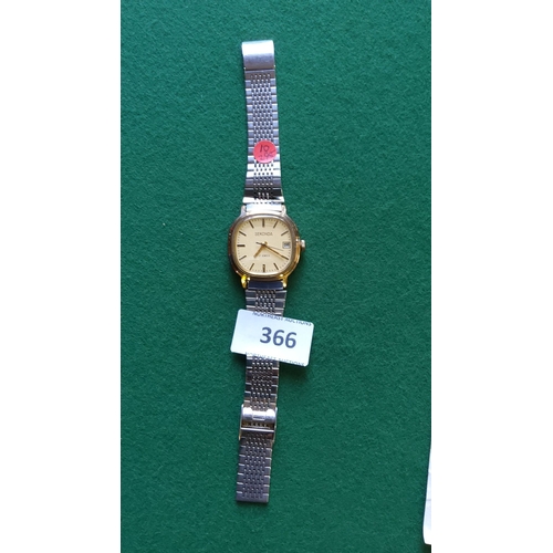 366 - Sekonda wristwatch features a gold-tone dial with date display and a stainless steel bracelet. It in... 