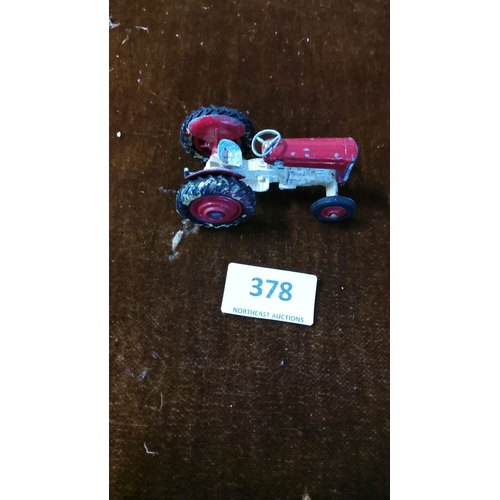 378 - Vintage red toy tractor, die-cast metal construction, from the early to mid-20th century design, fea... 