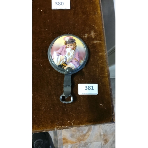 381 - Vintage 1930 crown cap bottle opener featuring hand-painted romantic portrait.