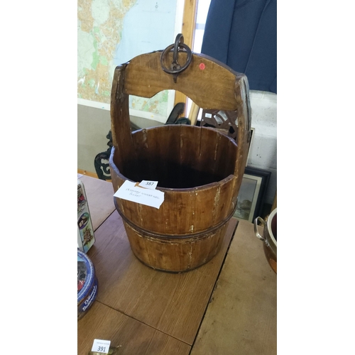 387 - 19th-century wooden well bucket with metal handle.