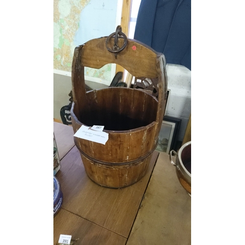 387 - 19th-century wooden well bucket with metal handle.