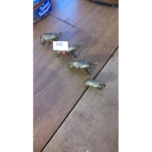 390 - Four brass elephant figurines, varied sizes, distinctive textured design.