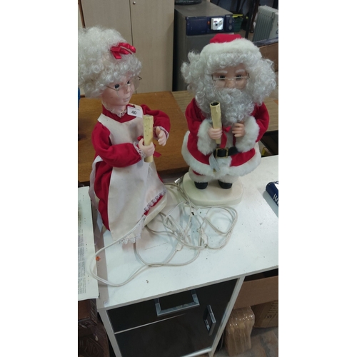 40 - Pair of electric Santa and Mrs. Claus festive figurines, featuring traditional red attire, curly wig... 