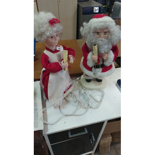 40 - Pair of electric Santa and Mrs. Claus festive figurines, featuring traditional red attire, curly wig... 