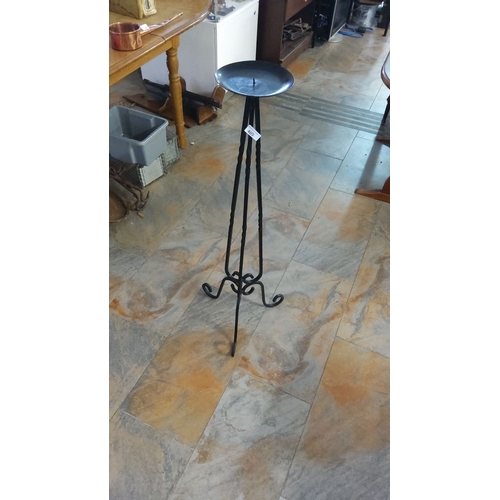 405 - Wrought iron candle holder with twisted tripod legs and an elegant scroll base design.