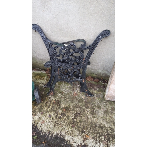 454 - Ornate black cast iron garden bench ends with intricate scrollwork design.