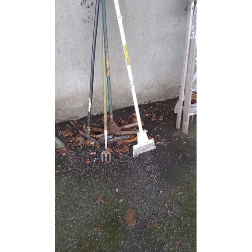 470 - Assorted vintage garden tools, includes rake, fork, and scraper with wooden and metal handles.