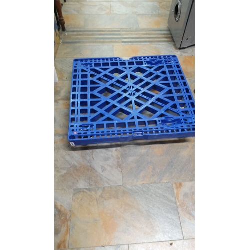 474 - Blue plastic dolly with four swivel caster wheels. Durable construction with a grid-like design for ... 