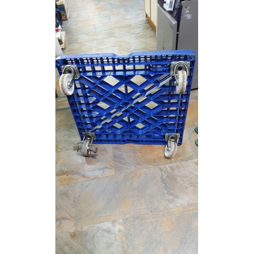 474 - Blue plastic dolly with four swivel caster wheels. Durable construction with a grid-like design for ... 