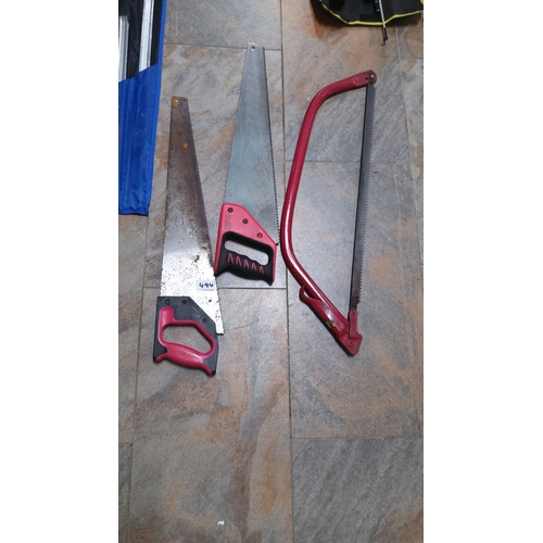 494 - Set of three assorted hand saws with red handles, including a bow saw and two traditional saws.