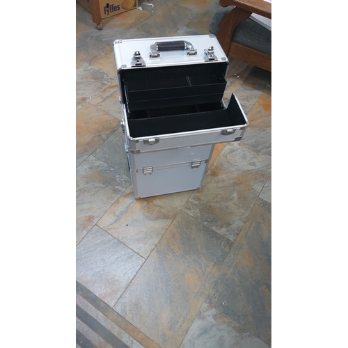 57 - Aluminum rolling storage case with retractable handle and lockable compartments. Measures approximat... 