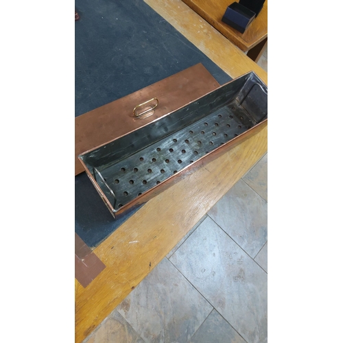 59 - Antique copper fish cooker features a perforated interior tray and carrying handle.