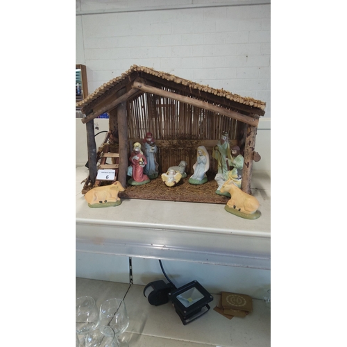 6 - Nativity scene crib with wooden stable and ten hand-painted ceramic figures, including Mary, Joseph,... 