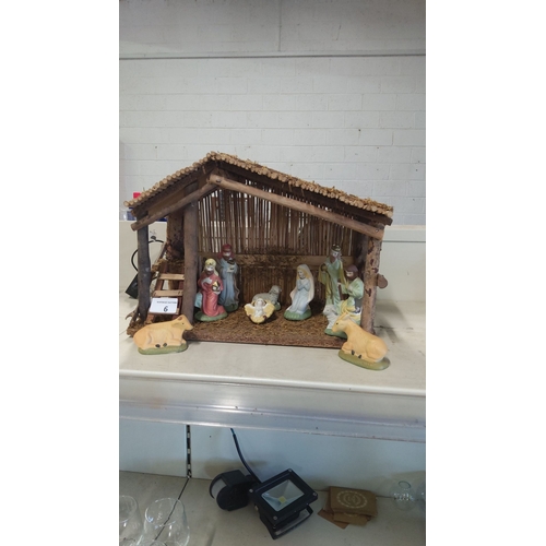 6 - Nativity scene crib with wooden stable and ten hand-painted ceramic figures, including Mary, Joseph,... 