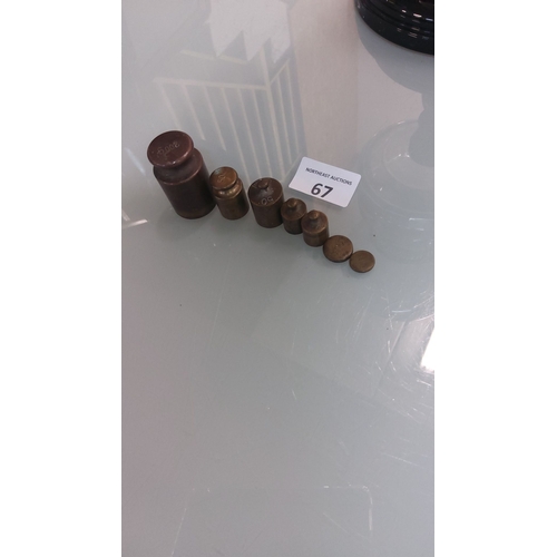 67 - Set of antique brass calibration weights in graduated sizes.