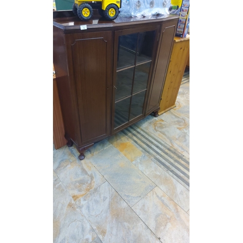 71 - Mahogany book display cabinet, featuring glass panes,ball feet and side panels. Classic style.