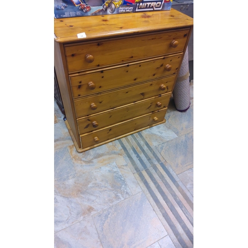 74 - Pine chest of drawers features four spacious drawers and round wooden knobs with a natural woodgrain... 