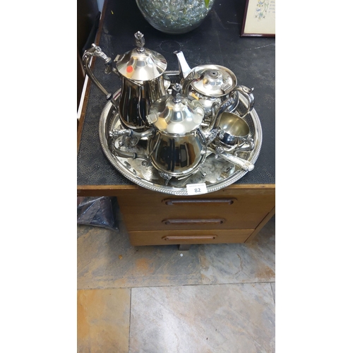 82 - Four-piece silver-plated tea set with ornate handles and finials, includes teapot, coffee pot, sugar... 