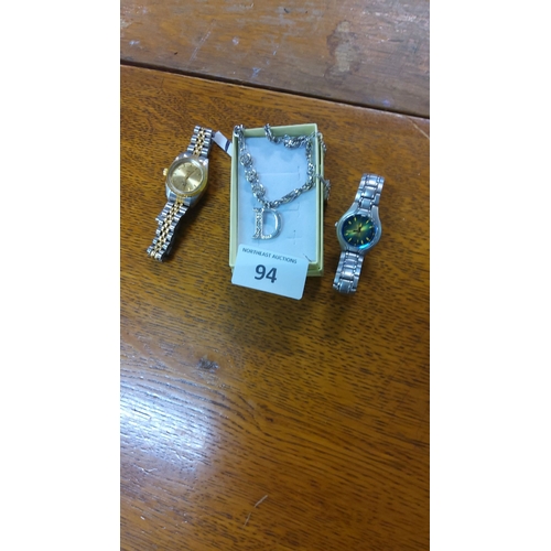 94 - Two wristwatches: one gold and silver tone, one silver with green dial. Includes a necklace with rhi... 