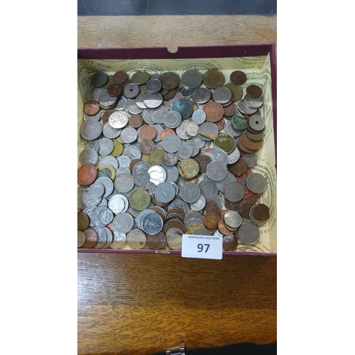 97 - Mixed lot of assorted world coins in a box, featuring various denominations and metals from multiple... 