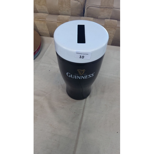 10 - Guinness collectible novelty money box, shaped as a pint glass, featuring iconic logo and design.