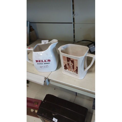 13 - Pair of Bell's Scotch Whisky ceramics, featuring pouring jugs with classic branding.