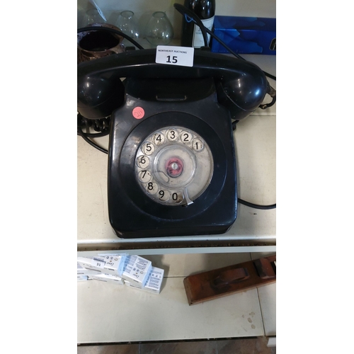 15 - Vintage rotary dial telephone, black bakelite, from the mid-20th century. Classic design.