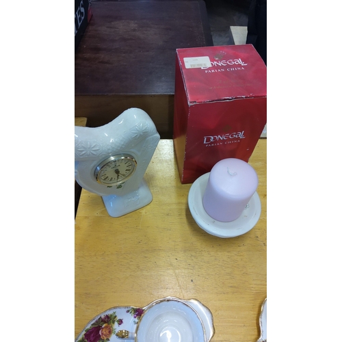 196 - Donegal Parian China clock, featuring floral relief design, alongside original box. Includes candle ... 