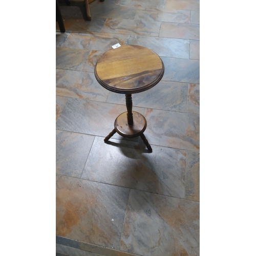 22 - Wooden plant stand with circular top and tripod base, showcasing classic rustic charm.