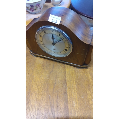 268 - Art Deco wooden mantel clock with chrome detailing and round clock face, featuring Arabic numerals, ... 