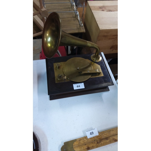 44 - Vintage brass gramophone replica with hinged wooden base, featuring a large horn and crank mechanism... 